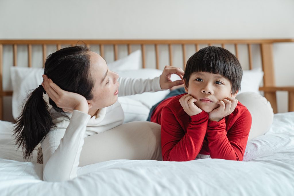 Parent setting a boundary with a child during a conversation about behavior